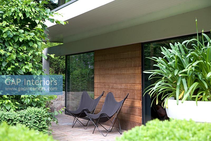 Contemporary chairs outside house