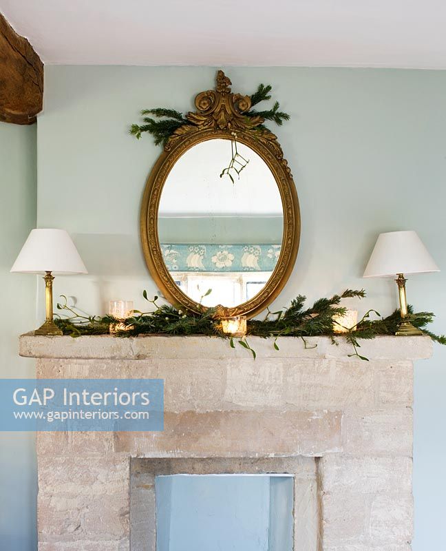 Cotswold stone mantlepiece with antique gilt mirror