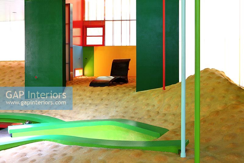 Colourful room with bumpy floor and seating area