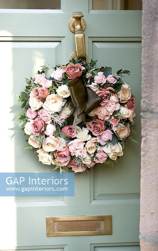 Classic front door with wreath of Roses