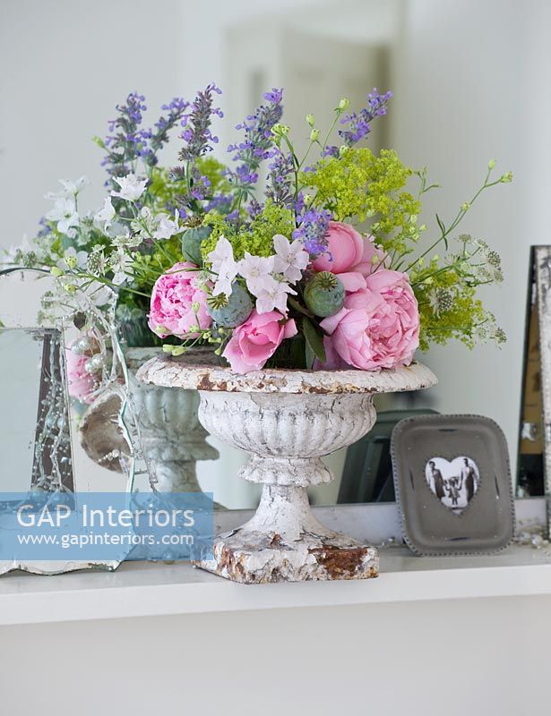 Vintage urn with arrangement of Roses, Catmint and Ladys Mantle flowers