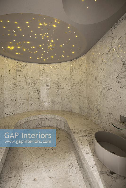 Contemporary marble bathroom with seating area