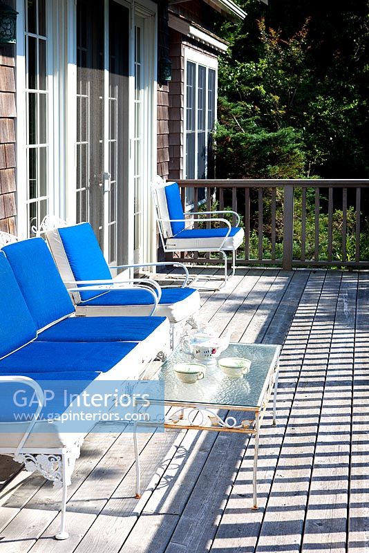 Blue benches on wooden balcony