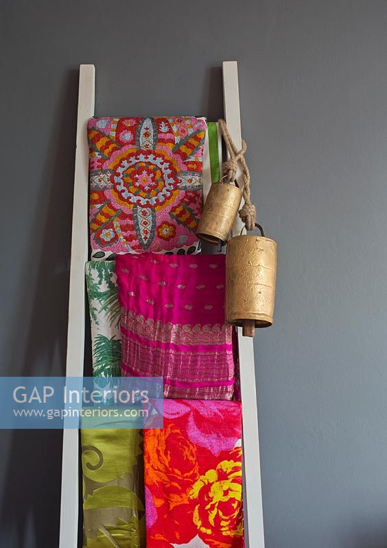 Colourful fabrics on ladder