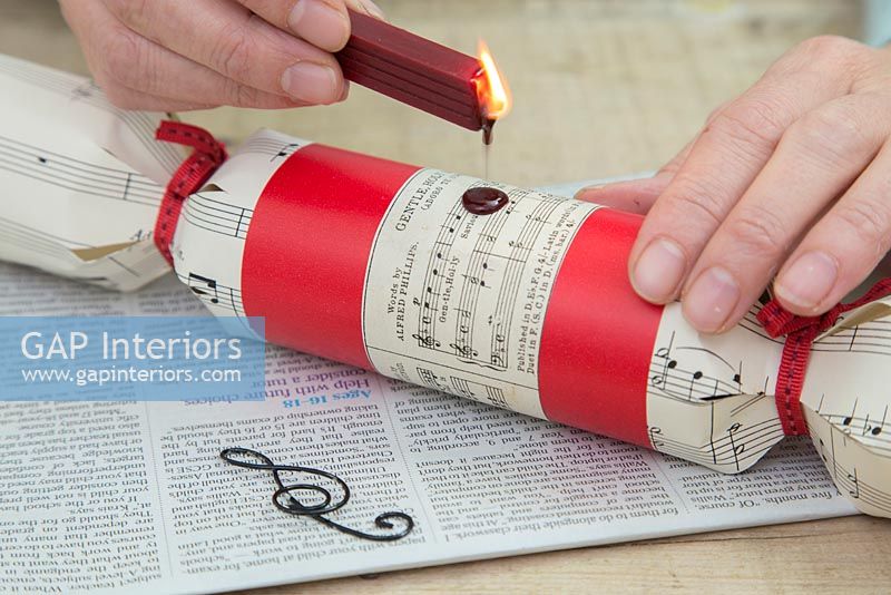 Step by Step guide for making Christmas Crackers from scratch - dripping molten wax onto cracker