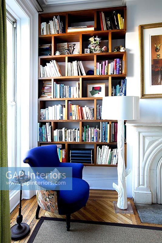 Blue armchair by bookcase