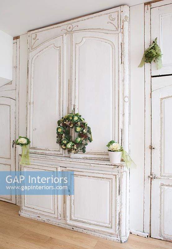 Distressed white kitchen units with christmas decorations