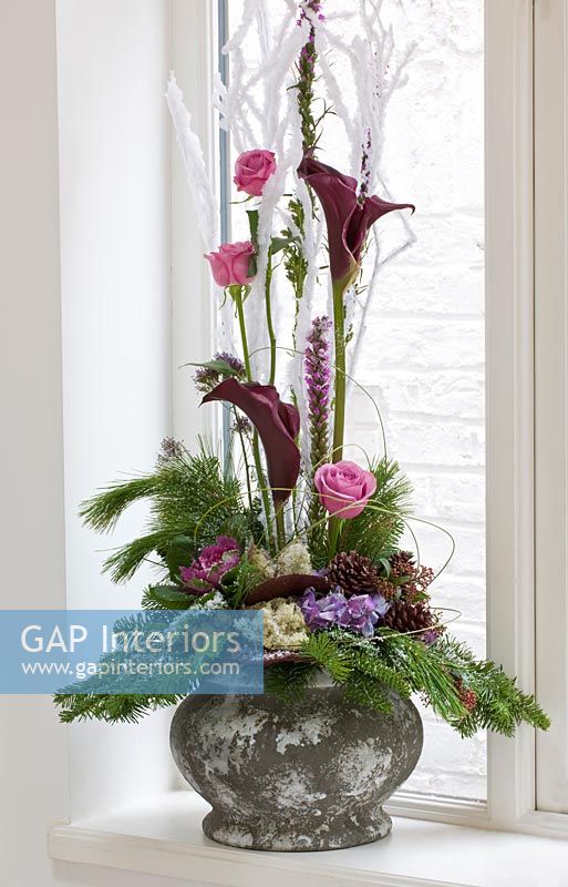 Christmas flower arrangement with conifer foliage, Roses, Calla lilies and pine cones