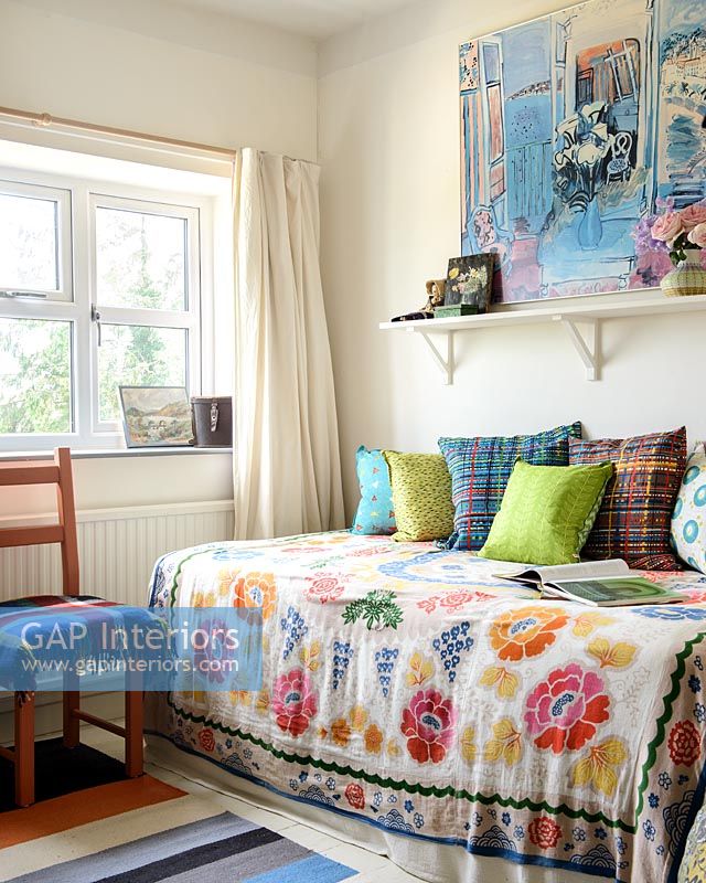 Colourful cushions and bedspread