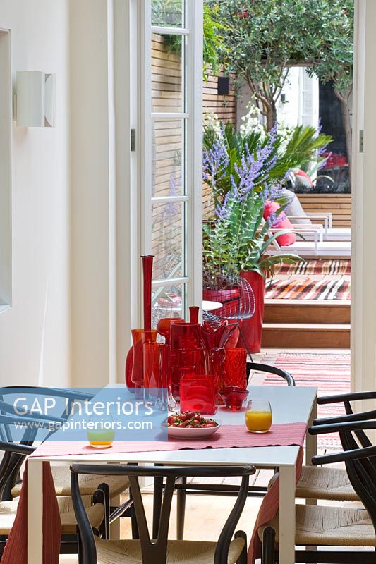 Collection of red glassware on dining table