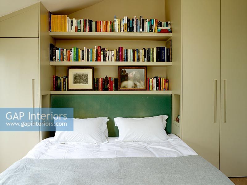 Bookshelves above bed