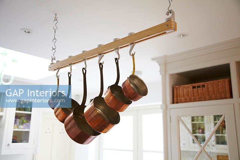 Copper pots hanging from rail
