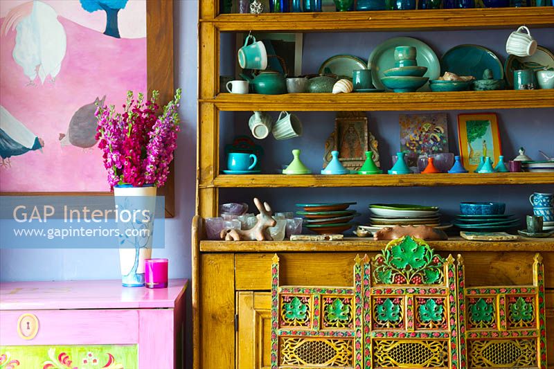 Colourful crockery on dresser