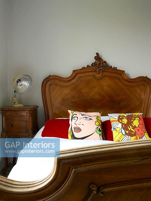 Vintage bed with pop art cushions