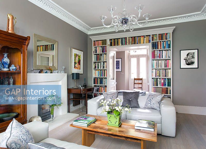 Modern living room with book storage over doorway