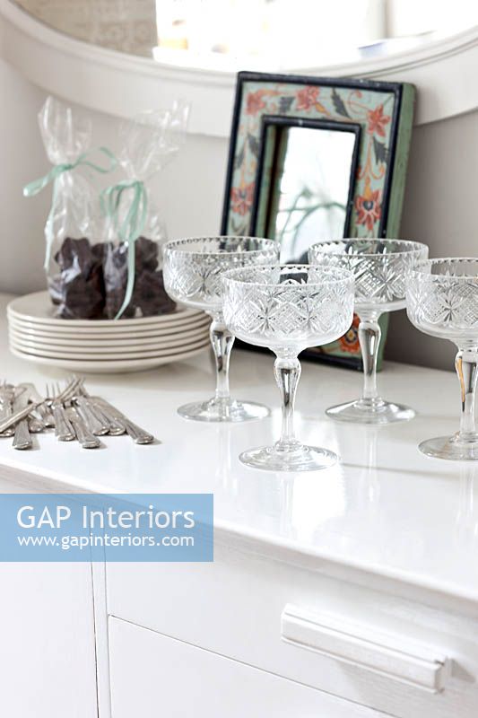Crystal glasses on white sideboard
