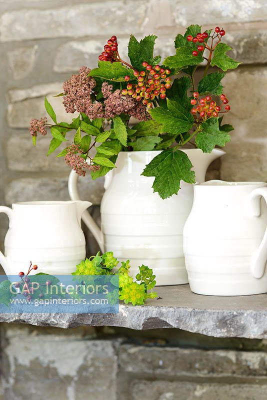 Flowers and berries in white jug