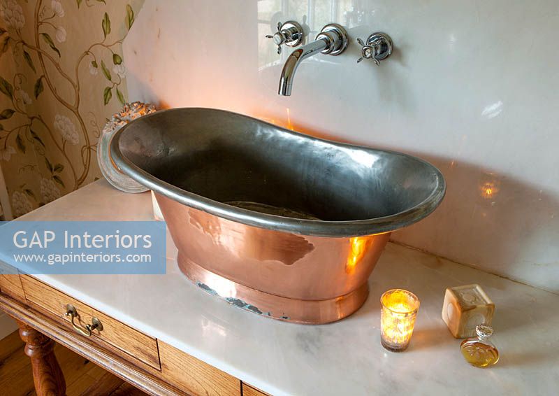 Copper sink on marble vanity unit