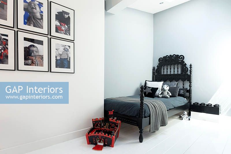 Black bed in childs bedroom