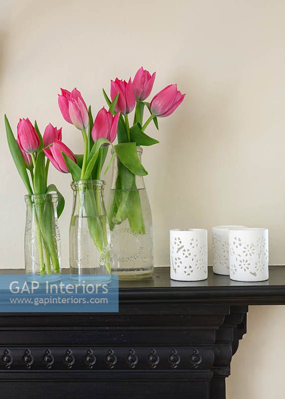 Bottles of Tulips on mantlepiece