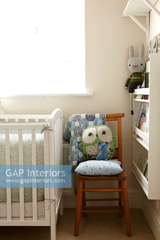 Wooden chair next to cot