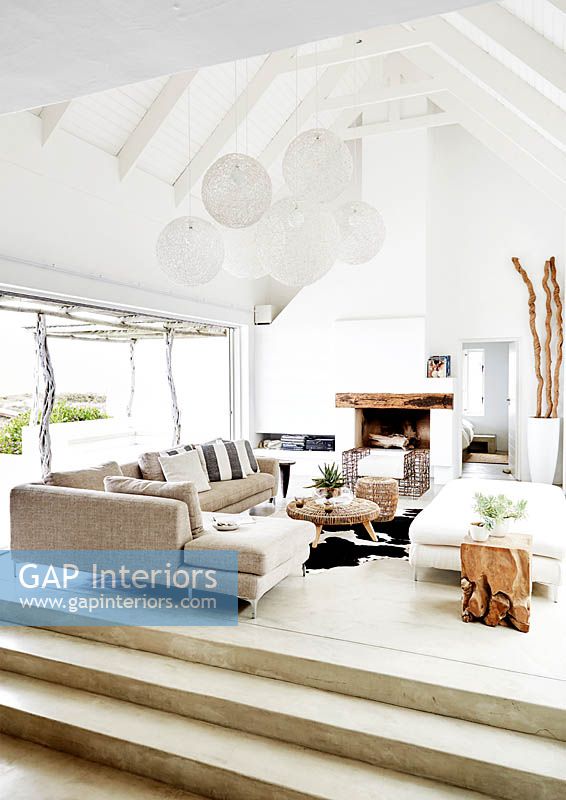 White living room with vaulted ceiling