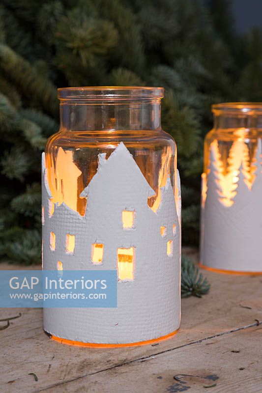 Clay Lanterns - glass jars wrapped with a textured clay cityscape 
