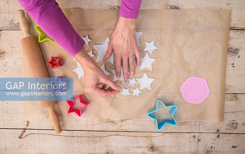 Making clay stars - Use a wooden skewer to create small holes on the tip of each star