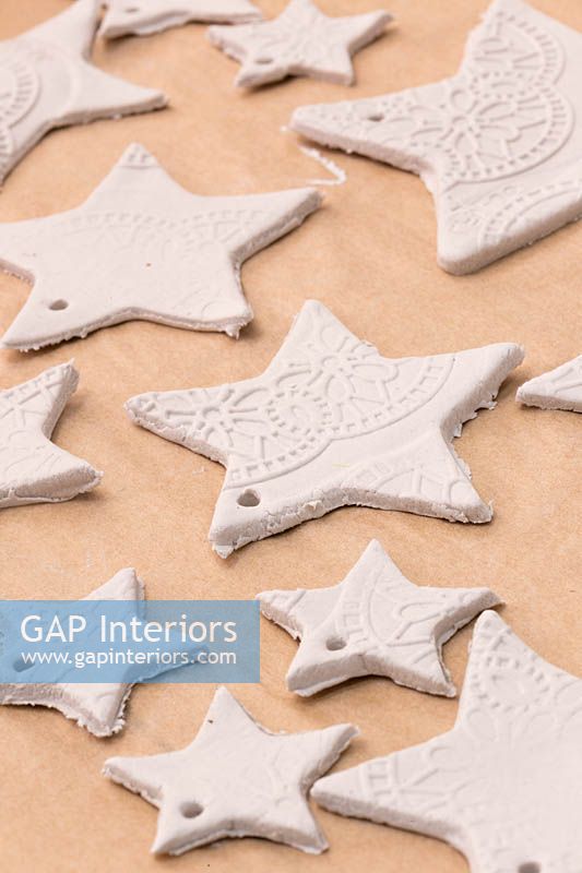 Making clay stars - A variety of different sized stars cut out from the modelling clay, with small holes added for hanging 