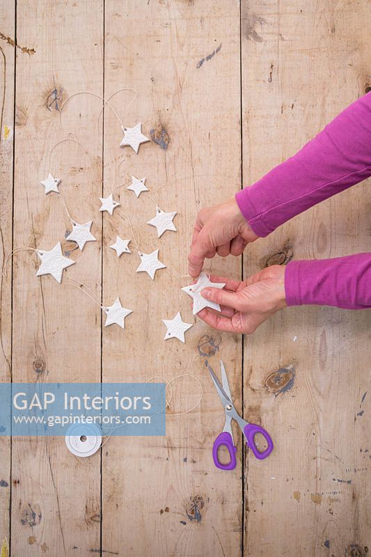 Making clay stars - Adding string to the stars so they can be hung