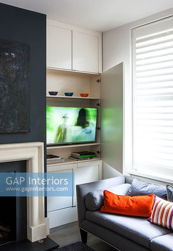 White painted panelling concealing television