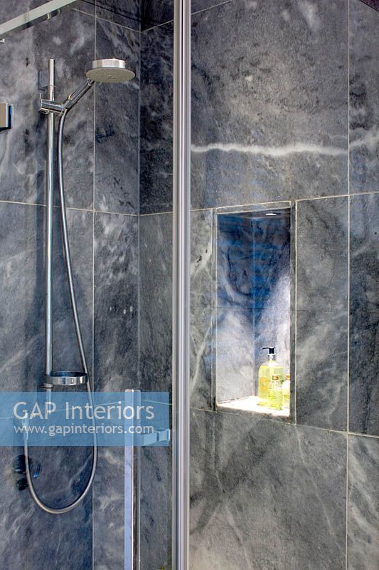 Grey marble shower with storage alcove