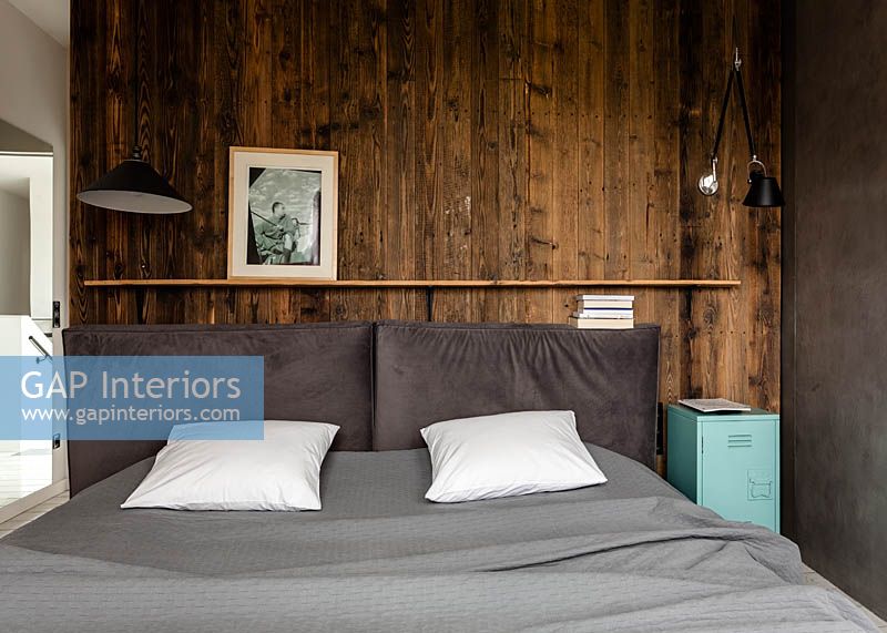 Wooden cladding behind bed