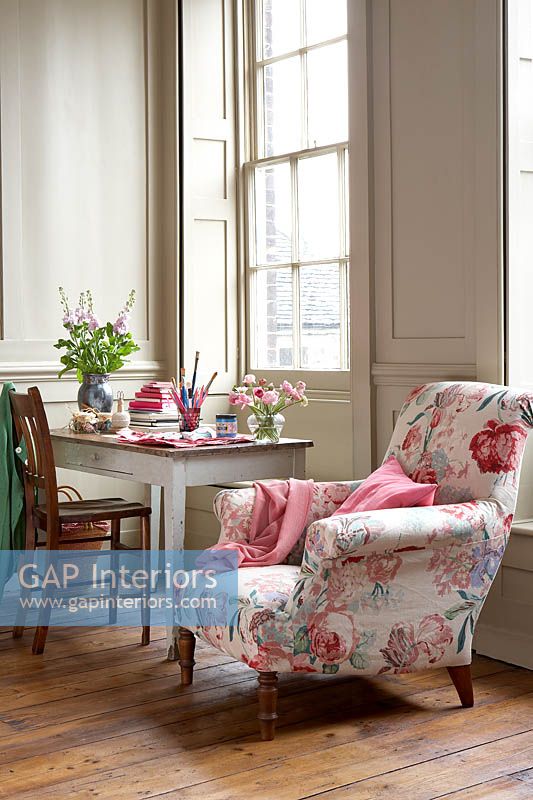 Floral armchair beside desk