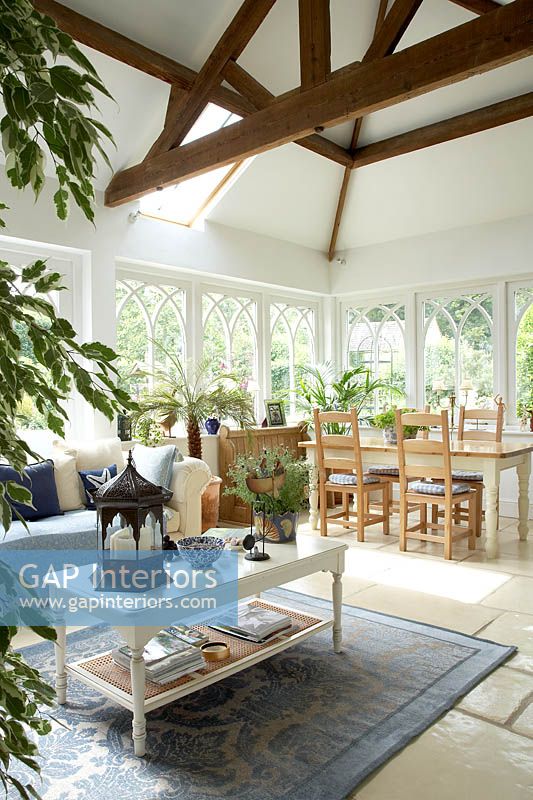 Open plan seating and dining areas with houseplants