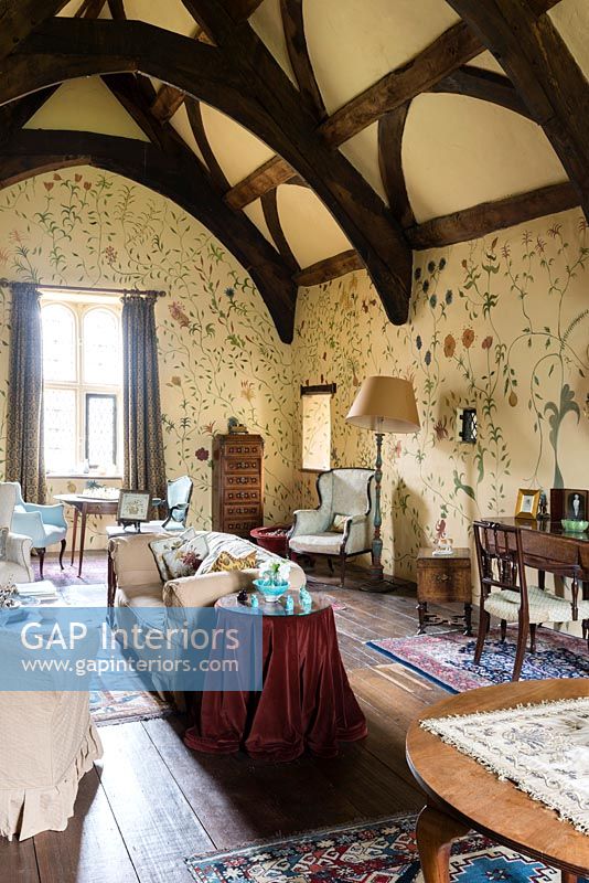 The Great chamber with handpainted floral wall design by Arabella Arkwright and antique furniture - Cothay Manor