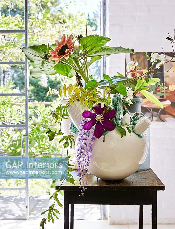 Vase of Clematis, Wisteria and Sunflowers in bathroom