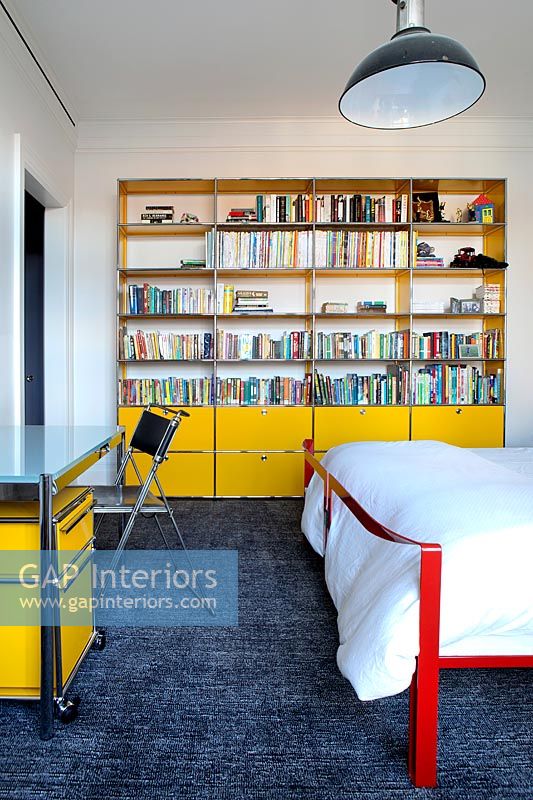 Yellow bookcase in bedroom