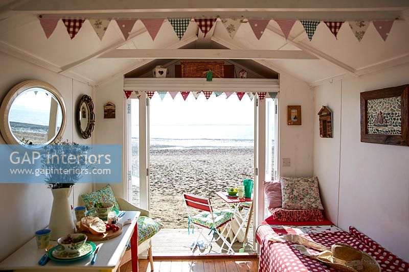 Interior of beach hut with view out to beach