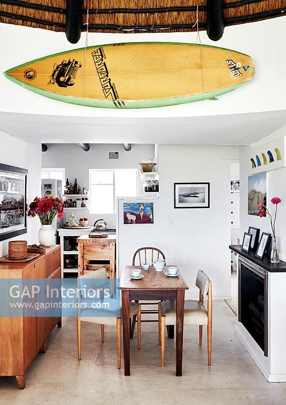 Detail of open plan dining area with surfboard