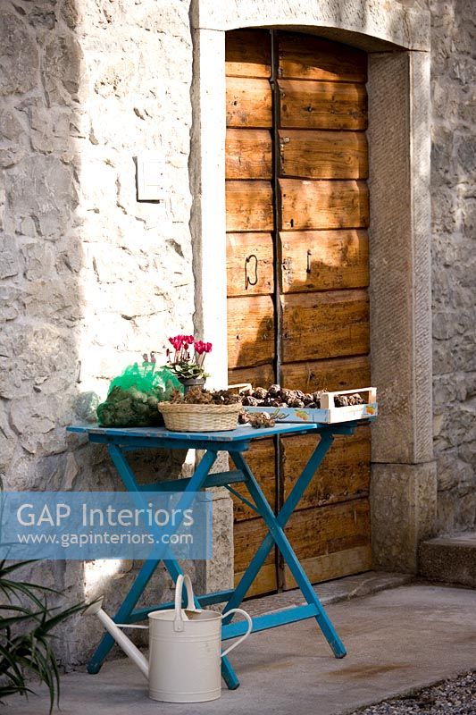 Garden table outside wooden door