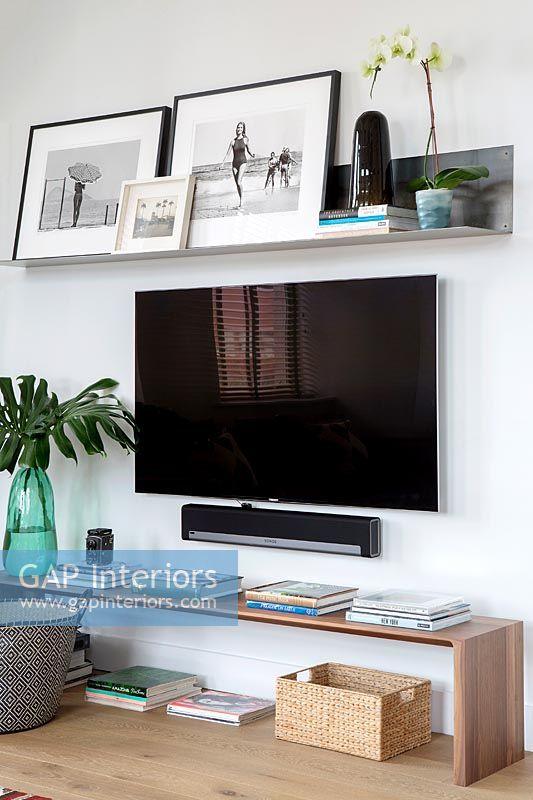 Large wall mounted flat screen television in contemporary living room