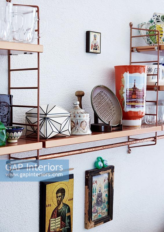 Eclectic items on wall mounted shelving 