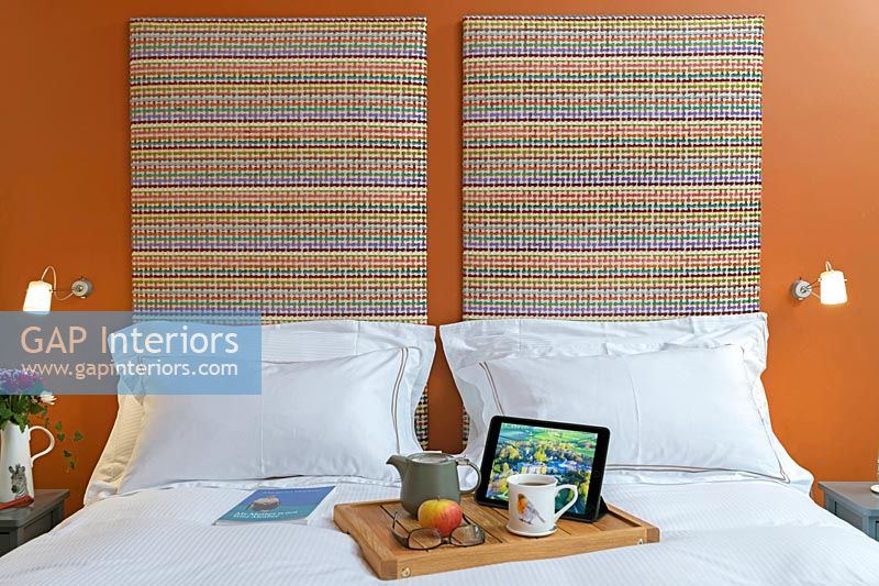 Breakfast tray on bed with large headboards