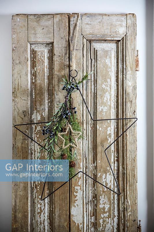Star shaped Christmas decorations on old wooden door 