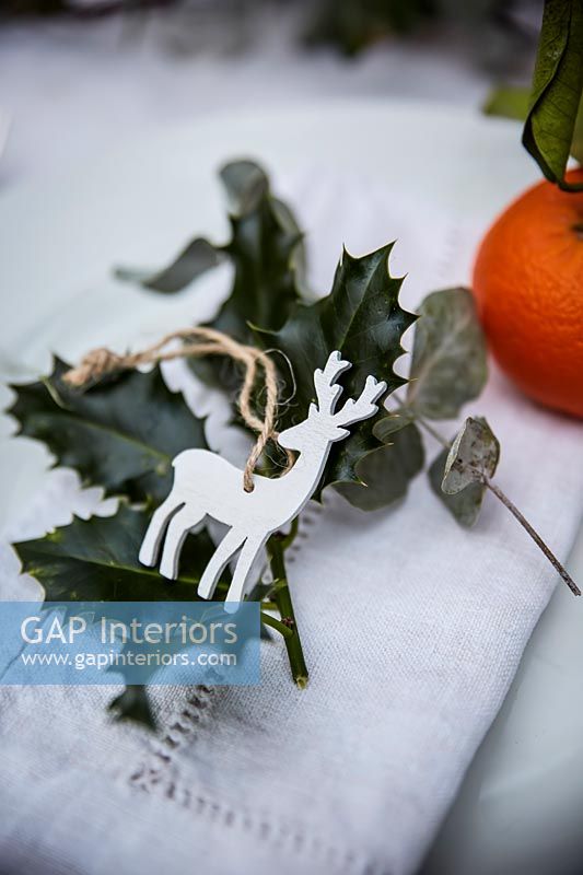 Place setting on dining table decorated for Christmas dinner 
