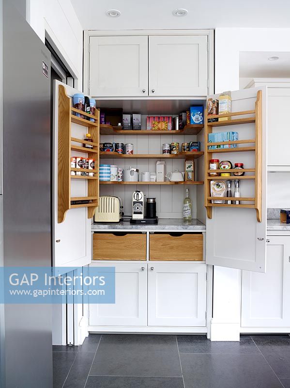 Coffee maker and toaster in large kitchen cabinet 