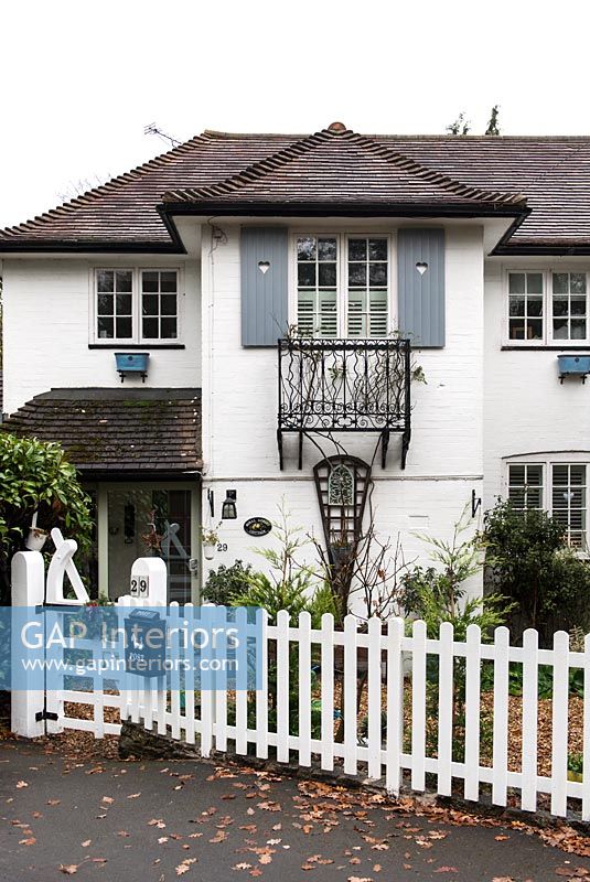 Classic house exterior with white picket fence 