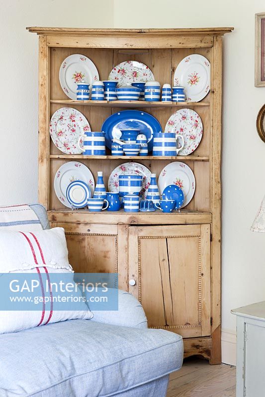 Display of blue and white Cornishware ceramics and floral plates on dresser 