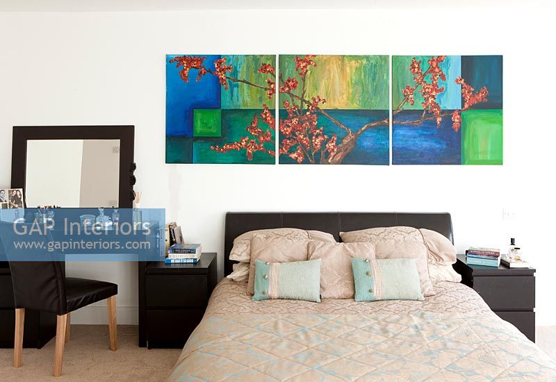 Modern bedroom with dressing table and colourful painting 